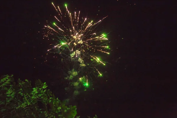 A photo of a salute in the night sky. Bright texture of festive fireworks. Abstract holiday background with various colors fireworks light. New Year's, Christmas lights in the sky, colorful lights. — Stock Photo, Image