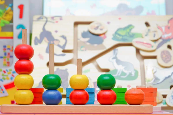 Pyramid build from colored wooden rings. Toy for babies and toddlers to joyfully learn mechanical skills and colors and numbers. baby toys collection isolated on white background. — Stock Photo, Image