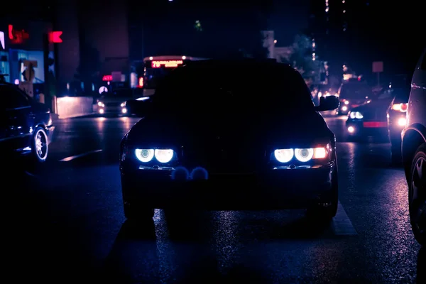 Nattvisning av bilar. Vägen i staden på natten med gula och röda elektriska ljus för bilar under de kommer hem. Bilar tävla på natten. Endast ljus i natten vagnar. — Stockfoto