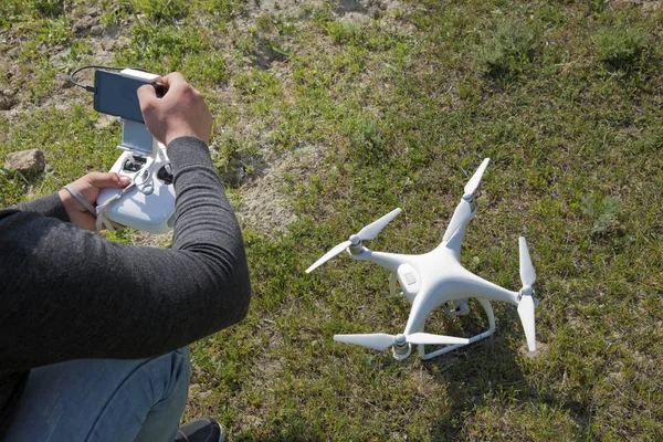 White drone with digital camera flying in sky over mountain Operation of drone in air .White drone with digital camera flying in sky over mountain Drone with high resolution digital camera.