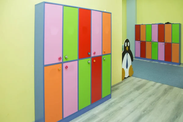 strong rows of color lockers in kindergarden dressing room in pool, children room . colorful of kid cabinet, wooden furniture for kindergarden or kids room. changing rooms and lockers of kindergarten
