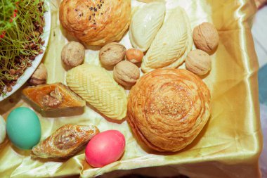 Semeni. Mum. Khoncha. Cehennemde, fındık, bektaşi üzümü, ceviz. Geleneksel shekerbura, yumurta, mutaki ve pakhlava Novruz sembolü olarak beyaz arka planda xoncha, Azerbaycan bayramı .