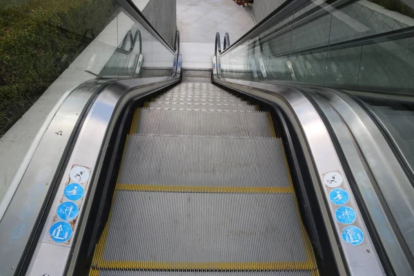 Moving escalator in the business center of a city . Modern escalator electronic system moving. — ストック写真