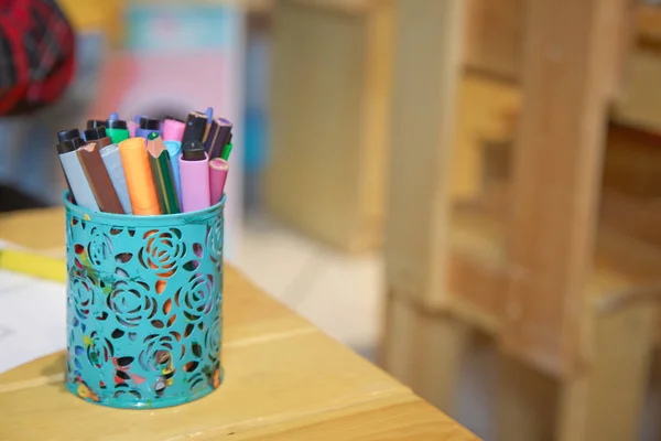 Box for pens and pencils . Colored pencils in a pencil case on the wooden table . Color pencils in aqua case . — Stock Photo, Image