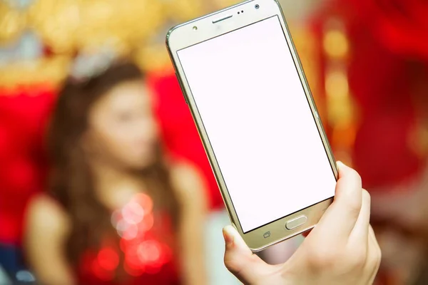 Your phone\'s screen is white and you can write text. The girl holds a gold phone in her hand.