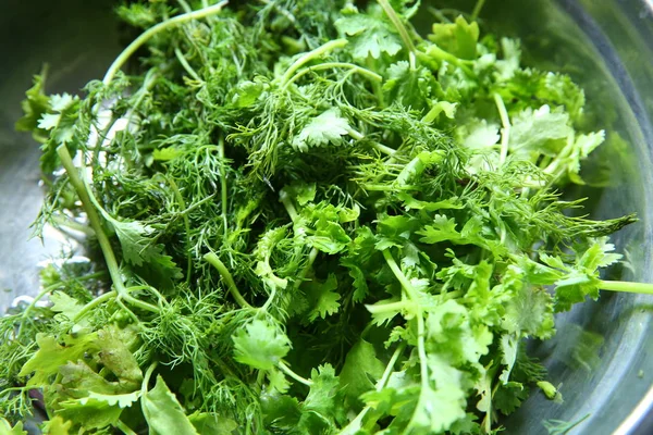 Green leaves of the annual Anethum graveolens, used as herb and spice. Macro food photo close up . Fresh coriander in plate.Fresh dill and coriander fronds in wooden bowl, also called dill weed. — Stock Photo, Image