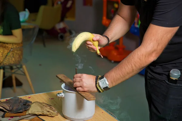 Nitrogen frozen bananas. Submerse a banana in liquid nitrogen -320 F and notice how cold it becomes. You can hammer a nail into wood before it shatters like glass. Nail with banana on board.