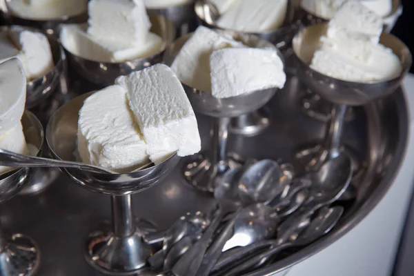 White ice cream in metal ware in the tray. Selective focus. Stainless ice cream cup that arrange in the . Ice cream in two retro metal bowls on a table . — 스톡 사진