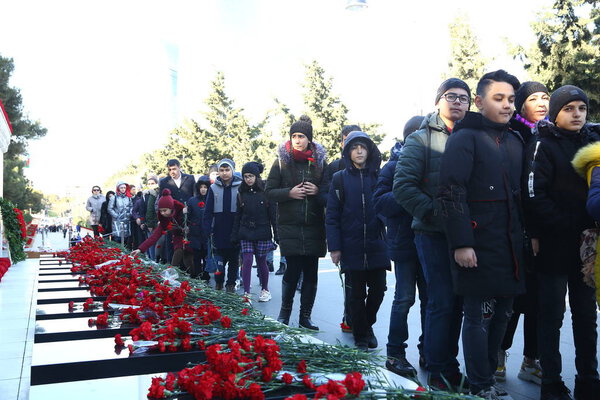 People visiting Alley of Martyrs on anniversary of 20th January tragedy when Soviet Army attacked Baku in 1990, killing 137 people, wounding 744