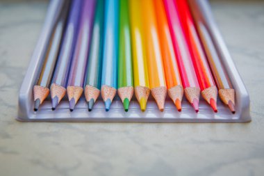 Close up. seamless colored pencils row with wave on lower side . Set of colored pencils on a white background That is arranged in a bar graph . line pencils . Color pencils isolated on white backgroun