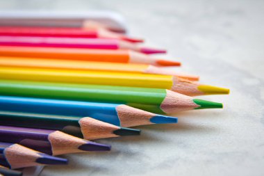 Close up. seamless colored pencils row with wave on lower side . Set of colored pencils on a white background That is arranged in a bar graph . line pencils . Color pencils isolated on white backgroun