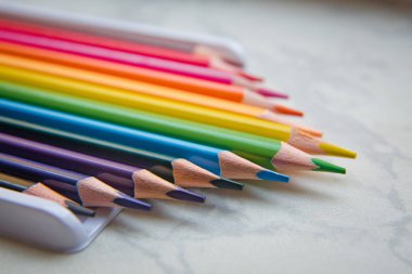 Close up. seamless colored pencils row with wave on lower side . Set of colored pencils on a white background That is arranged in a bar graph . line pencils . Color pencils isolated on white backgroun