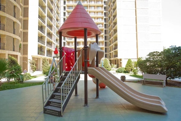 Children kids playground with play equipment outdoor. Kids playground with slides in the park. play ground red and white big plastic toy set for children school or city garden park .