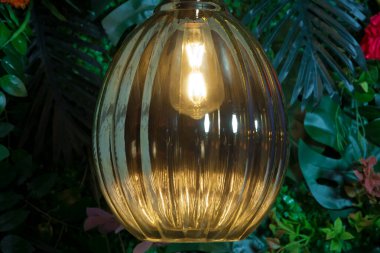 classic different retro light bulbs hanging on brick plastic green background at night . Beautiful retro luxury light lamp decor glowing.
