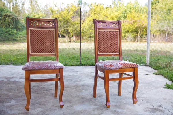 Old style wooden chair. Classic brown chair. wooden chair green background . Old chair on nature background .