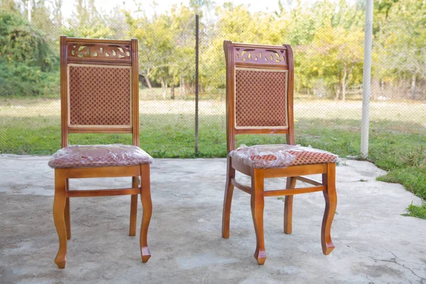 Old style wooden chair. Classic brown chair. wooden chair green background . Old chair on nature background .