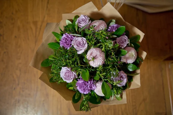 Flowers delivery. Pink peonies .Bouquet of flowers Purple in paper . Paper bouquet of fresh pink , purple roses . Pink flower in vase .