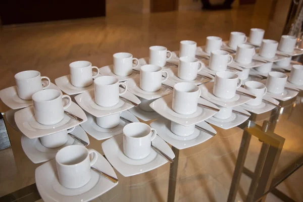 Dirty coffee cup and spoon setting on white saucer and wooden table after drinking in the morning in vintage style. — Stock Photo, Image