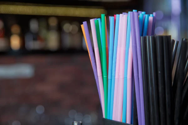 Macro photo drink straw. Stock photo black , blue, pink, plastic drink straws .Mixed vivid color of straw stick black background .