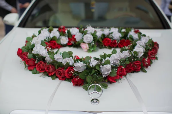 Wedding car and petals on top. Luxury wedding car decorated with flowers.