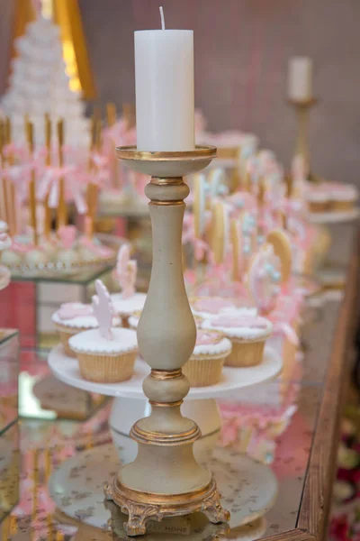 Candle isolated on the blur background. Candle for night dinner, Festival, Dinner, Holiday, New year . Pink Candy Bar . Brass candle holder