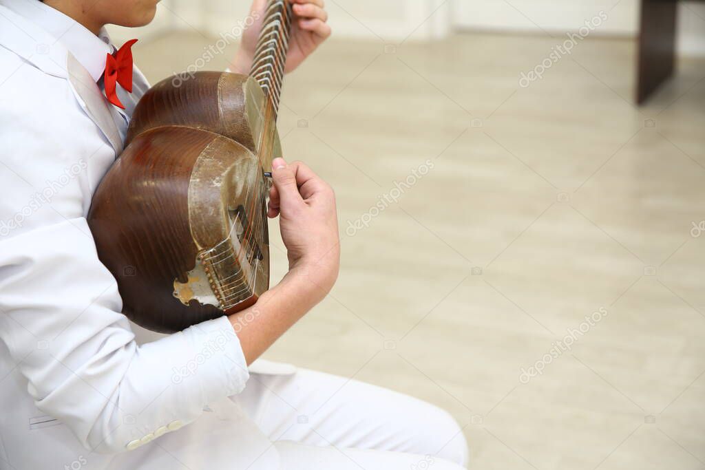 Azerbaijan Baku . 21.02.2020. Tar string instrument . Man playing on a classical folk instrument tar of Azerbaijan. A musician playing Azerbaijani traditional musical string instr