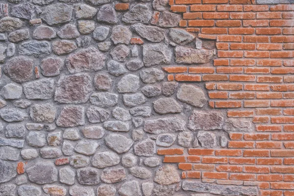 Orange brick and stones in wall