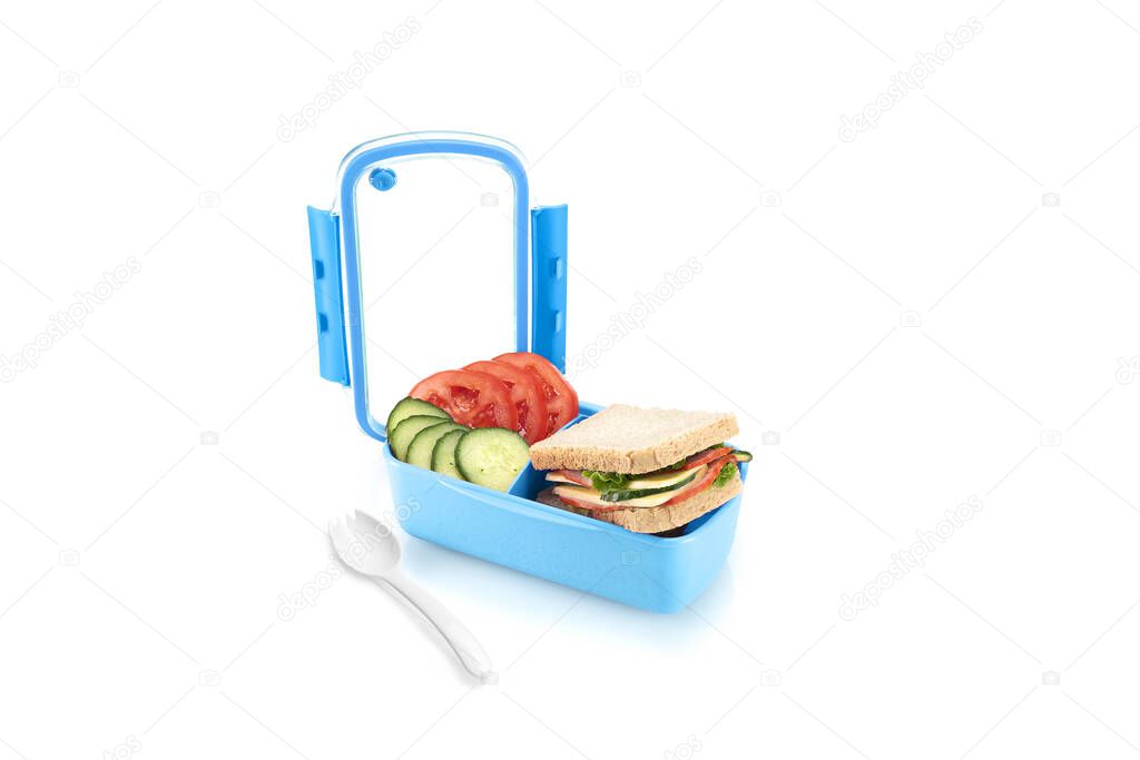 Healthy blue lunch box with sandwiches and vegetables for kids. Isolated on white background.