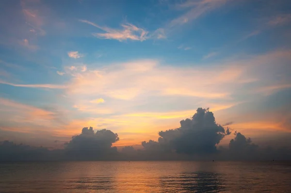Beautiful sunrise over the horizon in the sea with clouds, Hua Hin, Thailand.