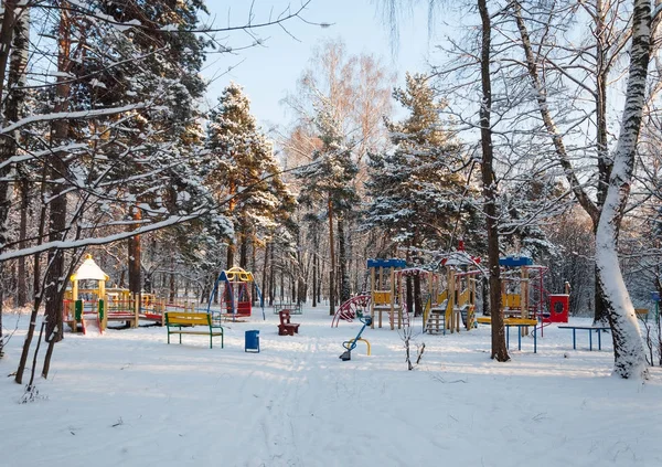 Empty children playground in the forest in winter — Stock Photo, Image