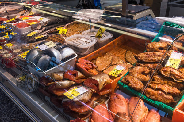 Riga, Latvia - October 28, 2019: Fresh fish at Riga Central Market. Smoked and salted fish at the Fish market in Riga, Latvia