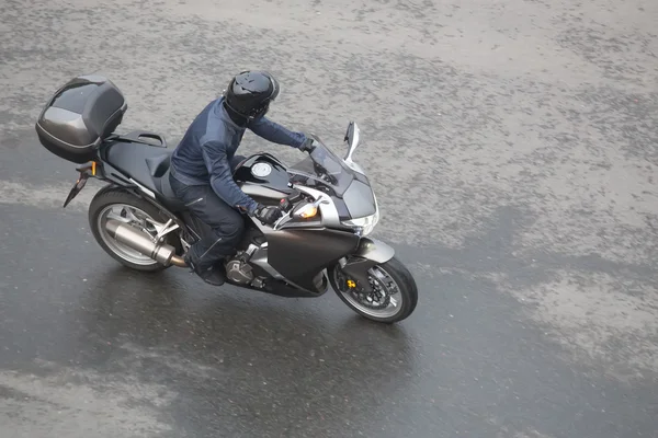 Motorradfahrer auf Motorrad fährt stadteinwärts — Stockfoto