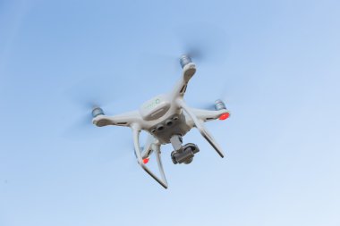 mavi gökyüzünde uçan quadcopter