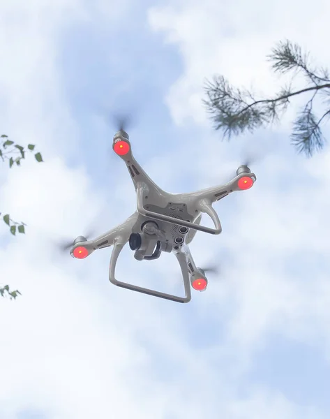 flying quadcopter in blue sky
