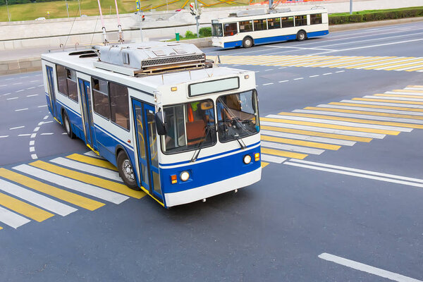 trolley moves along city street