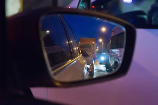 traffic on the road in the mirror of car