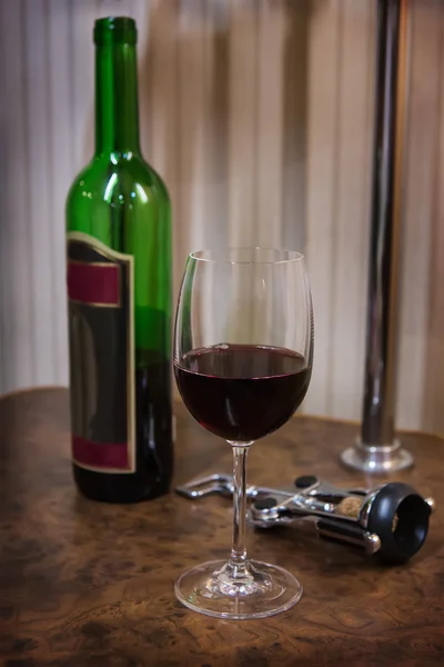 Bottle, glass of wine and corkscrew — Stock Photo, Image