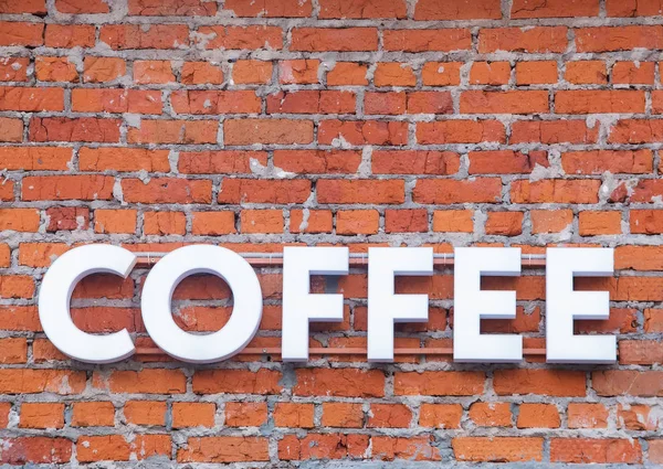 Coffee word in bulk letters on a brick wall — Stock Photo, Image