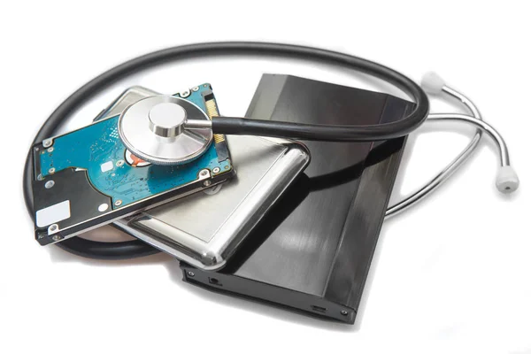 external hard drives and stethoscope on white background closeup