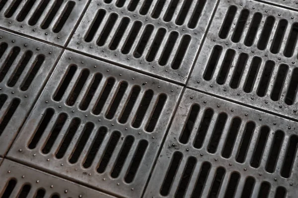 Metallic pavement grate — Stock Photo, Image