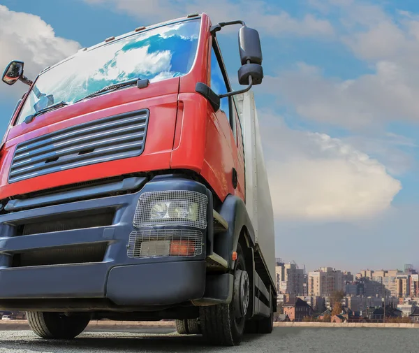 Big powerful truck in front of blue bright sky. — Stock Photo, Image