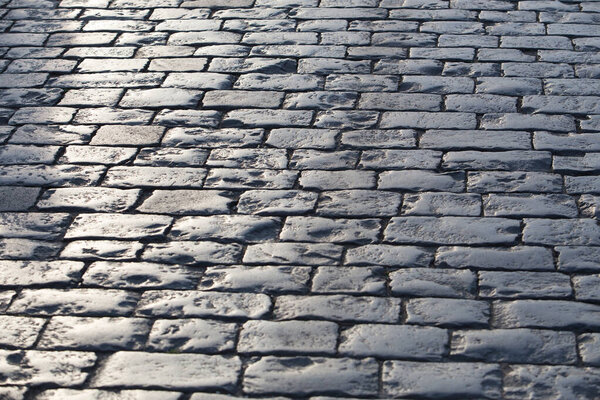 Old stone granite pavement. Background close-up.