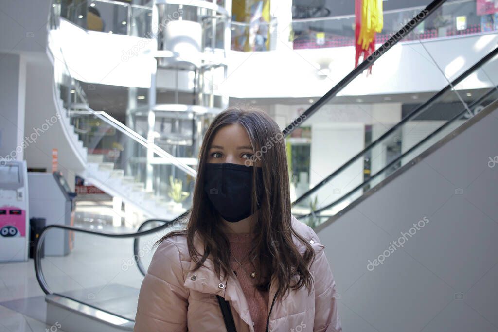 girl alone in black mask in shopping center
