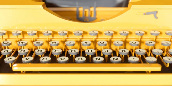 Yellow retro typewriter close-up on a yellow background — Stock Photo, Image
