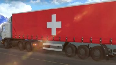 Otoyolda giden büyük bir kamyonun üzerinde İsviçre bayrağı görülüyor.