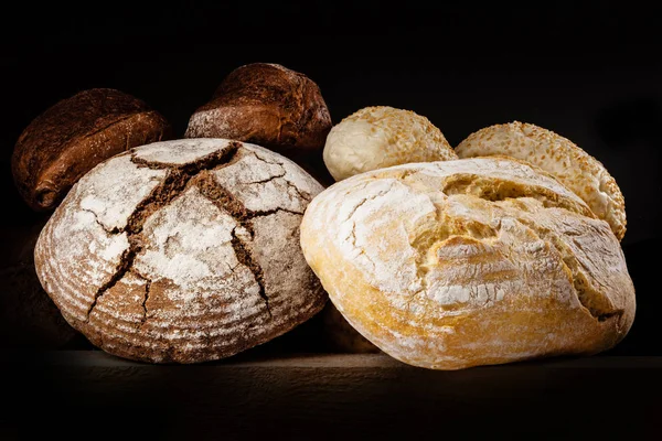 Fresh bread on black background. — Stock Photo, Image