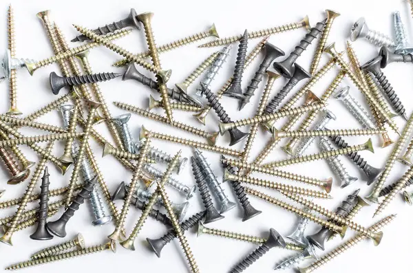 Pile of metal screws on a white background — Stock Photo, Image