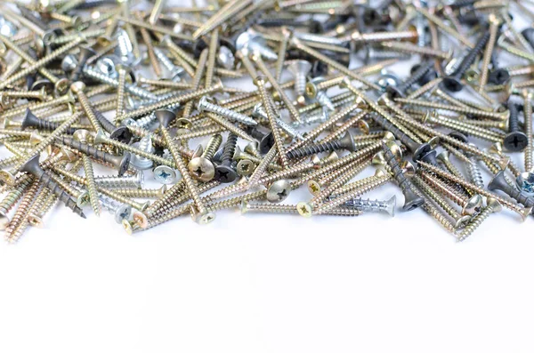 Pile of metal screws on a white background — Stock Photo, Image