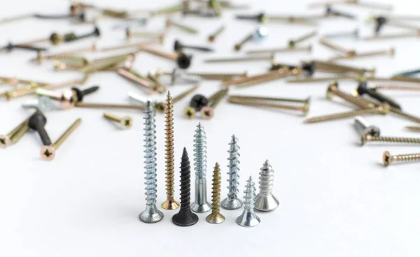 Pile of metal screws on a white background — Stock Photo, Image