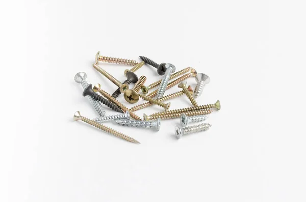 Pile of metal screws on a white background — Stock Photo, Image